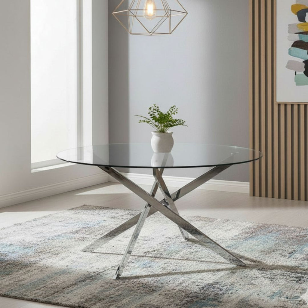 Modern glass dining table with metal base in a stylish room.