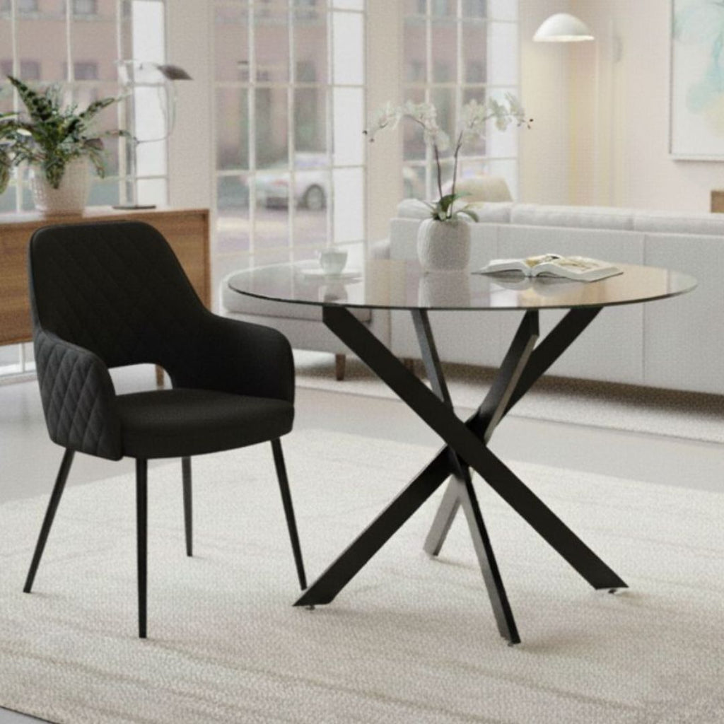 Modern black chair and glass dining table in a living room setting