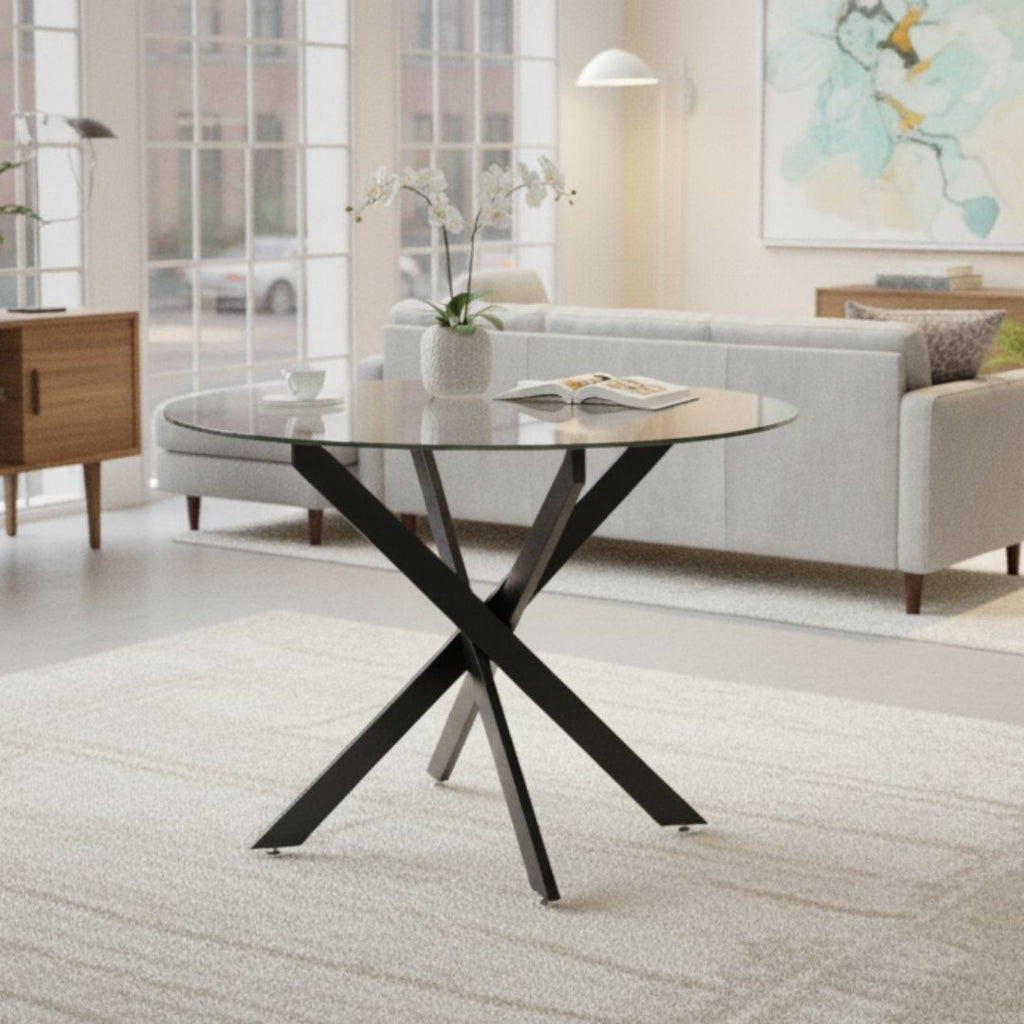 Modern living room with a round glass table and black metal legs.